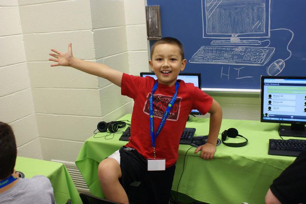 happy child in front of computers